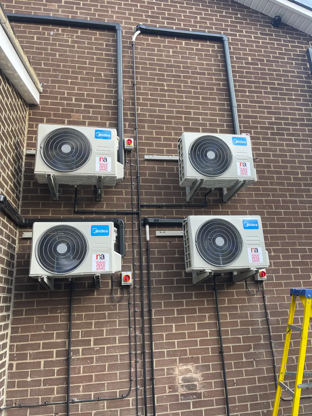 Outdoor unit installation by our Bolton engineers Four outdoor condensing units neatly installed on brickwork